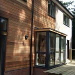 Side view of house with cedar cladding and aluminium windows